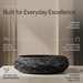 Black artificial stone oval table top wash basin 600x400x150 mm with rough natural rock textured exterior and smooth black interior, luxury designer countertop bathroom sink with modern styling and product dimensions.
