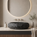 Black artificial stone oval table top wash basin 600x400x150 mm with rough natural rock textured exterior and smooth black interior, luxury designer countertop bathroom sink with modern styling and product dimensions.