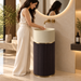 18x18x34 inch luxury freestanding pedestal wash basin with matte beige round bowl, dark brown fluted base, and elegant gold accents for modern bathrooms.