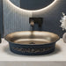 Black and champagne gold royal floral oval table top wash basin 580x370x150 mm featuring matte black exterior, metallic gold interior, antique gold ornamental scrollwork and scalloped rim for luxury bathroom countertops.