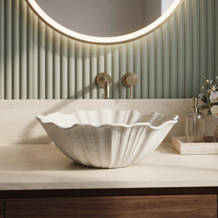White seashell design table top wash basin 470x390x170 mm featuring elegant scalloped wavy edges, vertically ribbed shell texture and natural speckled finish, luxury designer countertop bathroom sink for modern bathrooms.