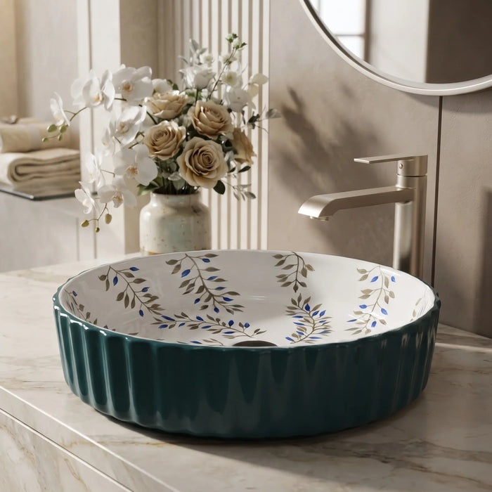 Teal green floral design round ceramic table top wash basin 400x400x120 mm featuring glossy ribbed exterior, white interior with elegant blue and olive botanical leaf patterns, luxury designer countertop bathroom sink.