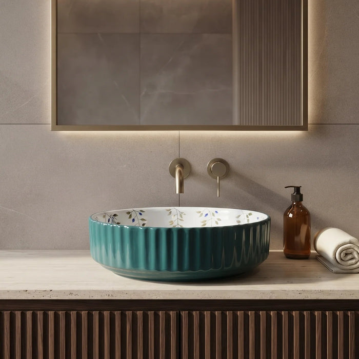 Teal green floral design round ceramic table top wash basin 400x400x120 mm featuring glossy ribbed exterior, white interior with elegant blue and olive botanical leaf patterns, luxury designer countertop bathroom sink.