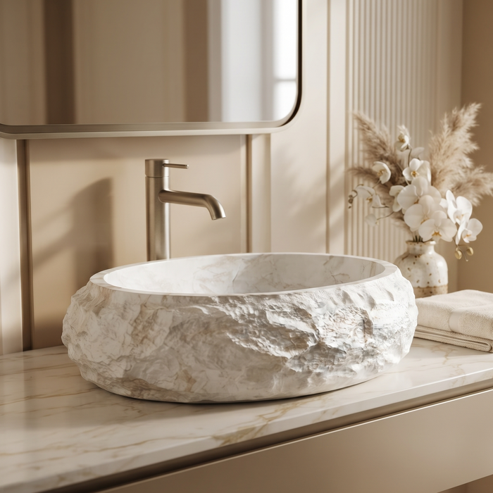 White artificial stone oval table top wash basin 600x400x150 mm with natural rough rock textured exterior, smooth marble-inspired interior and subtle beige veining, luxury designer countertop bathroom sink for modern bathrooms.