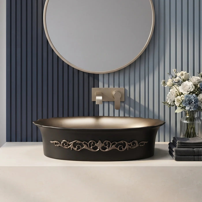 Black and champagne gold royal floral oval table top wash basin 580x370x150 mm featuring matte black exterior, metallic gold interior, antique gold ornamental scrollwork and scalloped rim for luxury bathroom countertops.