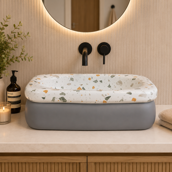 Bassino terrazzo design table top wash basin 460x320x140 mm with glossy white multicolor stone pattern and grey base for modern bathroom countertop.