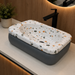 Bassino terrazzo design table top wash basin 460x320x140 mm with glossy white multicolor stone pattern and grey base for modern bathroom countertop.