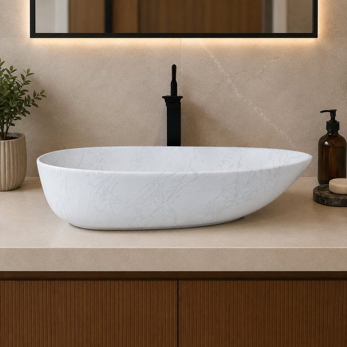 Bassino white marble pattern table top wash basin 560 × 355 × 130 mm with asymmetrical oval design for modern luxury bathroom countertops.