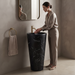Black marble-effect ceramic pedestal wash basin with tapered freestanding design, integrated bowl and 390 × 390 × 820 mm size for modern luxury bathrooms.