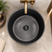 Black matte artificial stone freestanding pedestal wash basin with fluted cylindrical design and gold accent, 400×400×860 mm luxury bathroom sink.