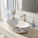 Blue and gold floral design oval table top wash basin 560x385x150 mm featuring glossy white interior, intricate ornamental blue patterns, elegant gold rim and base accents, luxury designer countertop bathroom sink.