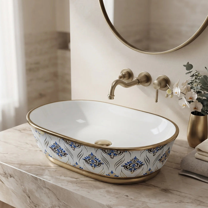 Blue and gold floral design oval table top wash basin 560x385x150 mm featuring glossy white interior, intricate ornamental blue patterns, elegant gold rim and base accents, luxury designer countertop bathroom sink.