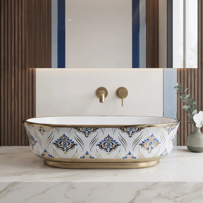 Blue and gold floral design oval table top wash basin 560x385x150 mm featuring glossy white interior, intricate ornamental blue patterns, elegant gold rim and base accents, luxury designer countertop bathroom sink.