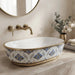 Blue and gold floral design oval table top wash basin 560x385x150 mm featuring glossy white interior, intricate ornamental blue patterns, elegant gold rim and base accents, luxury designer countertop bathroom sink.