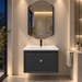 Charcoal grey 24 inch wall mounted bathroom vanity set with fluted storage cabinet, gold knob, glossy white ceramic basin and designer LED mirror, featuring modern luxury bathroom styling.