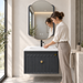 Charcoal grey 24 inch wall mounted bathroom vanity set with fluted storage cabinet, gold knob, glossy white ceramic basin and designer LED mirror, featuring modern luxury bathroom styling.