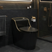Modern black toilet in a bathroom with dark tiles and gold fixtures.