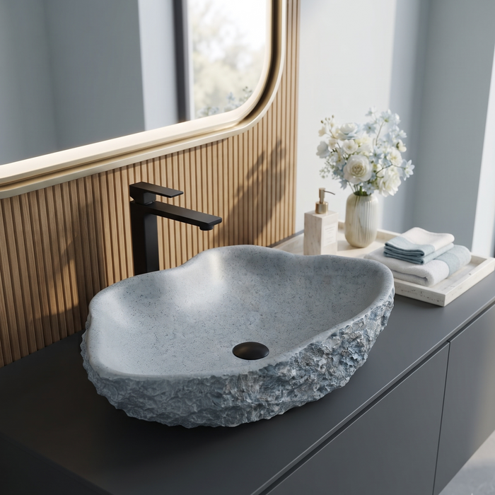 Grey artificial stone table top wash basin with organic free-form shape, speckled matte interior and rock-textured exterior, 490 × 370 × 140 mm.