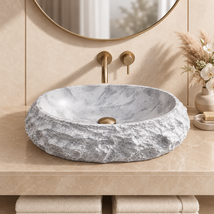 Grey oval artificial stone tabletop wash basin with a matte finish, rugged textured exterior and smooth patterned interior, measuring 500 × 400 × 150 mm.