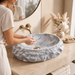 Grey oval artificial stone tabletop wash basin with a matte finish, rugged textured exterior and smooth patterned interior, measuring 500 × 400 × 150 mm.