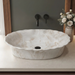 Ivory beige marble finish oval table top wash basin 580x370x150 mm featuring glossy white and beige marble pattern, elegant scalloped rim and spacious bowl for luxury bathroom countertops.