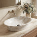 Ivory beige marble finish oval table top wash basin 580x370x150 mm featuring glossy white and beige marble pattern, elegant scalloped rim and spacious bowl for luxury bathroom countertops.