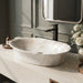Ivory beige marble finish oval table top wash basin 580x370x150 mm featuring glossy white and beige marble pattern, elegant scalloped rim and spacious bowl for luxury bathroom countertops.