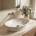 Ivory beige marble finish oval table top wash basin 580x370x150 mm featuring glossy white and beige marble pattern, elegant scalloped rim and spacious bowl for luxury bathroom countertops.
