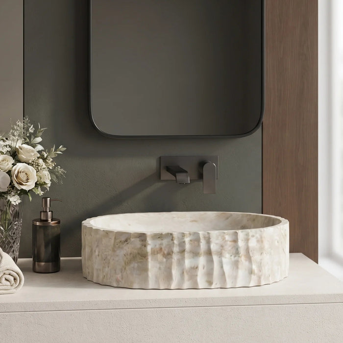 Ivory white marble finish oval table top wash basin with beige veining, vertical fluted exterior and 20 inch countertop design for modern luxury bathrooms.