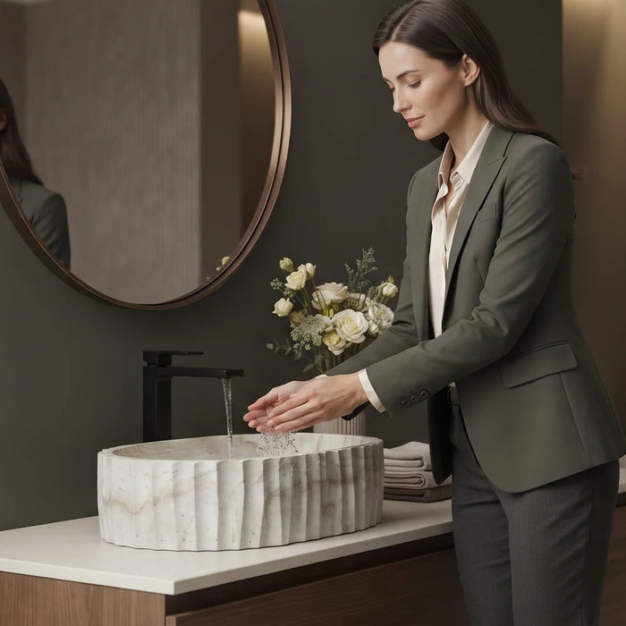 Ivory white marble finish oval table top wash basin with beige veining, vertical fluted exterior and 20 inch countertop design for modern luxury bathrooms.