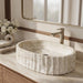 Ivory white marble finish oval table top wash basin with beige veining, vertical fluted exterior and 20 inch countertop design for modern luxury bathrooms.