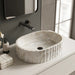 Ivory white marble finish oval table top wash basin with beige veining, vertical fluted exterior and 20 inch countertop design for modern luxury bathrooms.