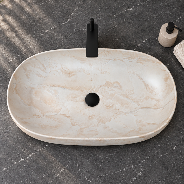 Oval ceramic table top wash basin with a matte cream and beige marble-pattern finish, measuring 675 × 350 × 140 mm.