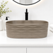 Taupe tabletop wash basin with a matte finish and wave-textured exterior, shown from multiple angles in a modern bathroom setting.