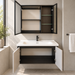 Wall-mounted bathroom vanity set with white basin, light grey cabinet, fluted door and dark-framed mirror cabinet.