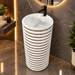 White and gold ceramic pedestal wash basin with glossy finish, sculpted cylindrical design and 440 × 440 × 820 mm size for modern luxury bathrooms.