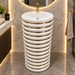 White and gold ceramic pedestal wash basin with glossy finish, sculpted cylindrical design and 440 × 440 × 820 mm size for modern luxury bathrooms.