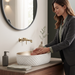 White and gold oval table top wash basin with diamond-textured exterior, measuring 500 × 360 × 150 mm, styled on a bathroom vanity counter.