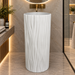 White artificial stone freestanding pedestal wash basin with matte finish, round bowl and elegant vertical wave textured design, 400x400x840 mm for modern luxury bathrooms.