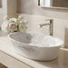 White floral design oval table top wash basin 580x370x150 mm featuring elegant grey botanical line art, glossy white appearance, scalloped curved rim and decorative floral patterns for luxury bathroom countertops.