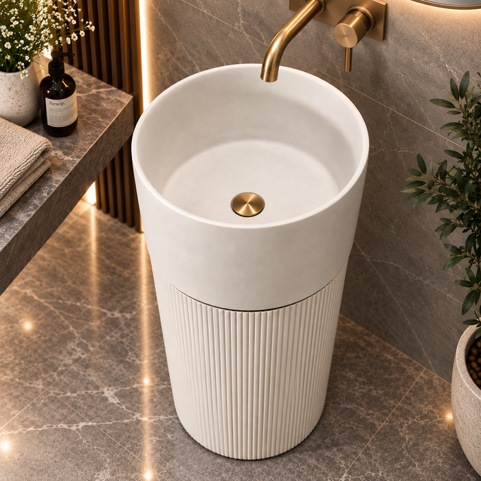 White matte artificial stone freestanding pedestal wash basin with round bowl, fluted design and metallic accent, 430x430x860 mm for modern luxury bathrooms.