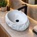 White oval Artificial stone table top wash basin 500 × 350 × 150 mm with rugged natural stone-inspired textured exterior and smooth interior, designed for modern luxury bathrooms.