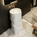 White sculptural freestanding pedestal wash basin 17.7 x 17.7 x 33.9 inch with irregular textured design for modern luxury bathroom interior.
