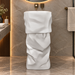 White sculptural freestanding pedestal wash basin 17.7 x 17.7 x 33.9 inch with irregular textured design for modern luxury bathroom interior.