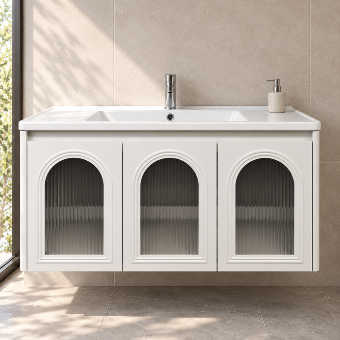 White wall-mounted bathroom vanity set with three arched fluted glass doors, integrated ceramic basin and mirror storage cabinet, 1000 mm wide.