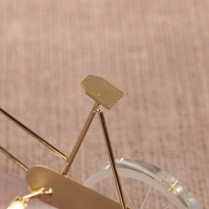 Featuring a delicate bicycle design crafted with gleaming gold accents and transparent glass elements creates a dynamic visual effect, making it a perfect statement piece for modern, eclectic, or minimalist interiors. BSP-8130
